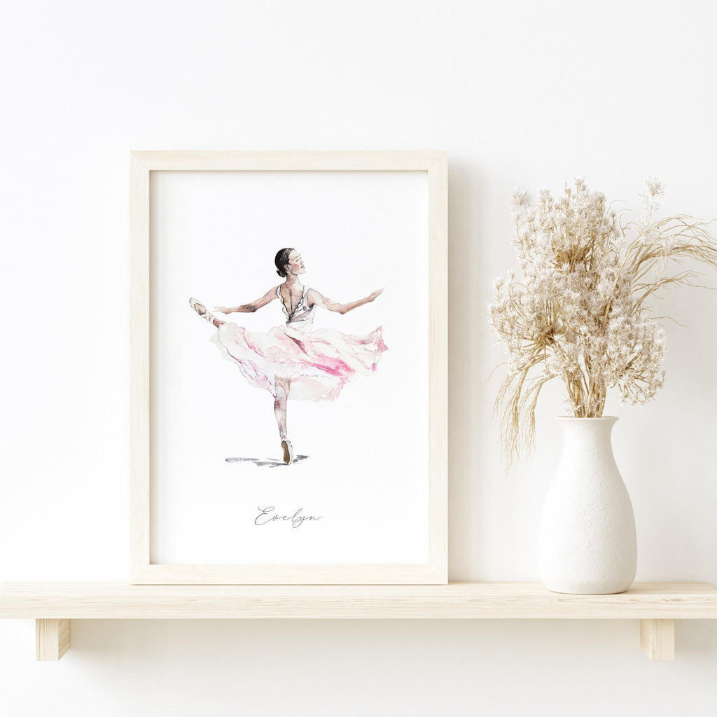 Framed artwork of a ballerina in a pink dress on a shelf with a vase of dried flowers.